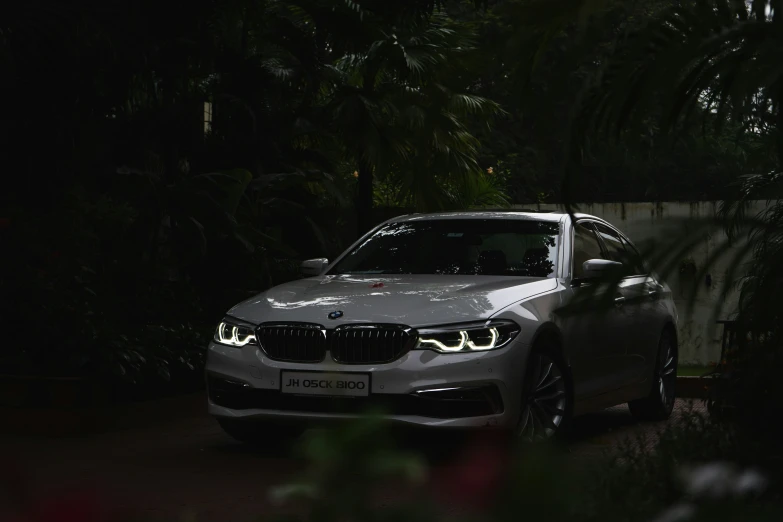 the white car is glowing on at night time