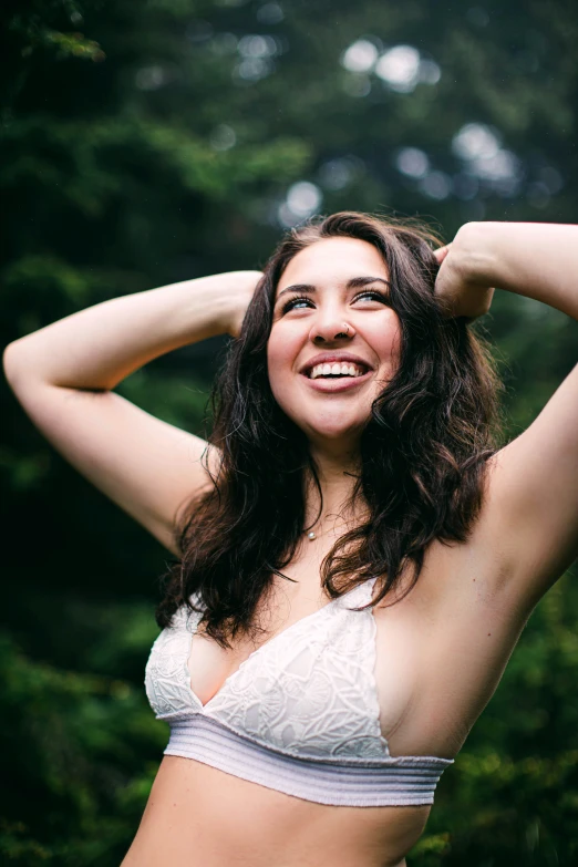 a beautiful woman in a white bikini smiling at the camera