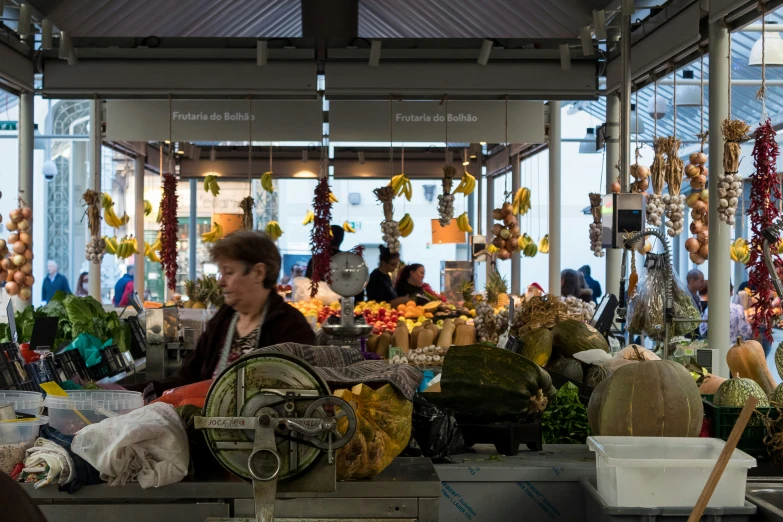an open market is shown with people shopping for produce
