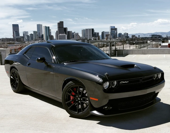 a sports car sitting in front of a city skyline