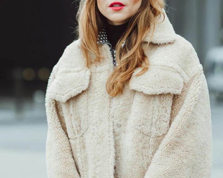 a woman in a fur coat and hat