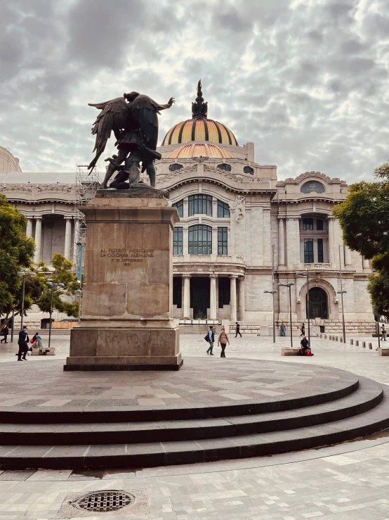 an ornate building and fountain in front of it