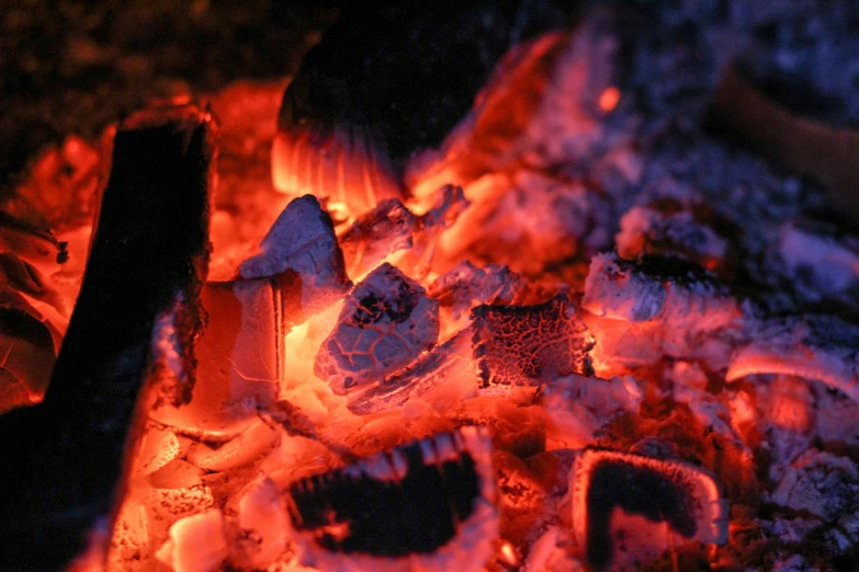 coal fire with flames and pieces of silver on it