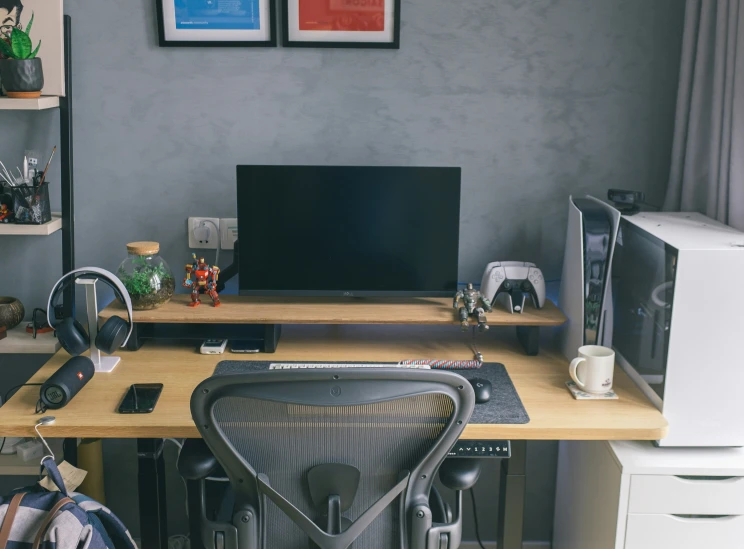 the desk is full of a computer monitor, printer and other items