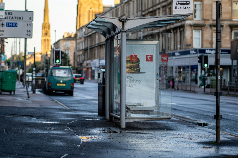 a bus stop near the street with some cars