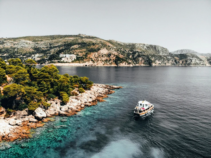 a small boat is sailing across the open water