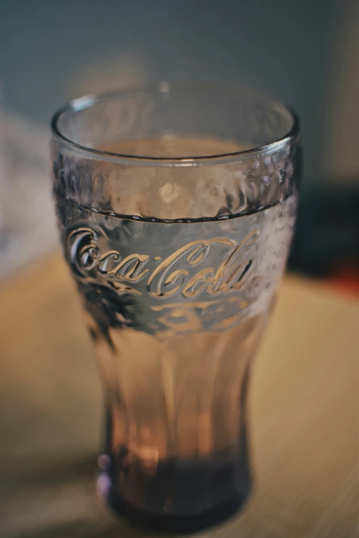 a glass is sitting on a wooden table