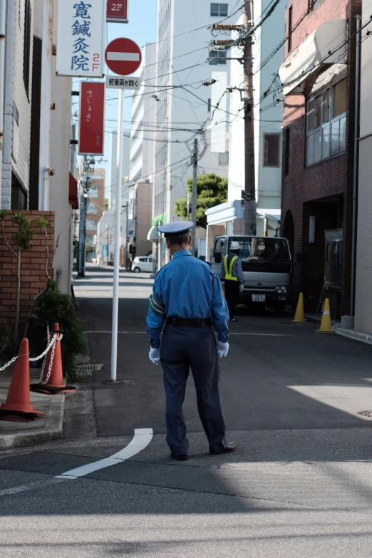 a man walks across the street on a city sidewalk