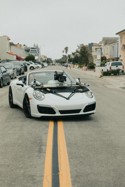 a white sports car parked on the side of the road