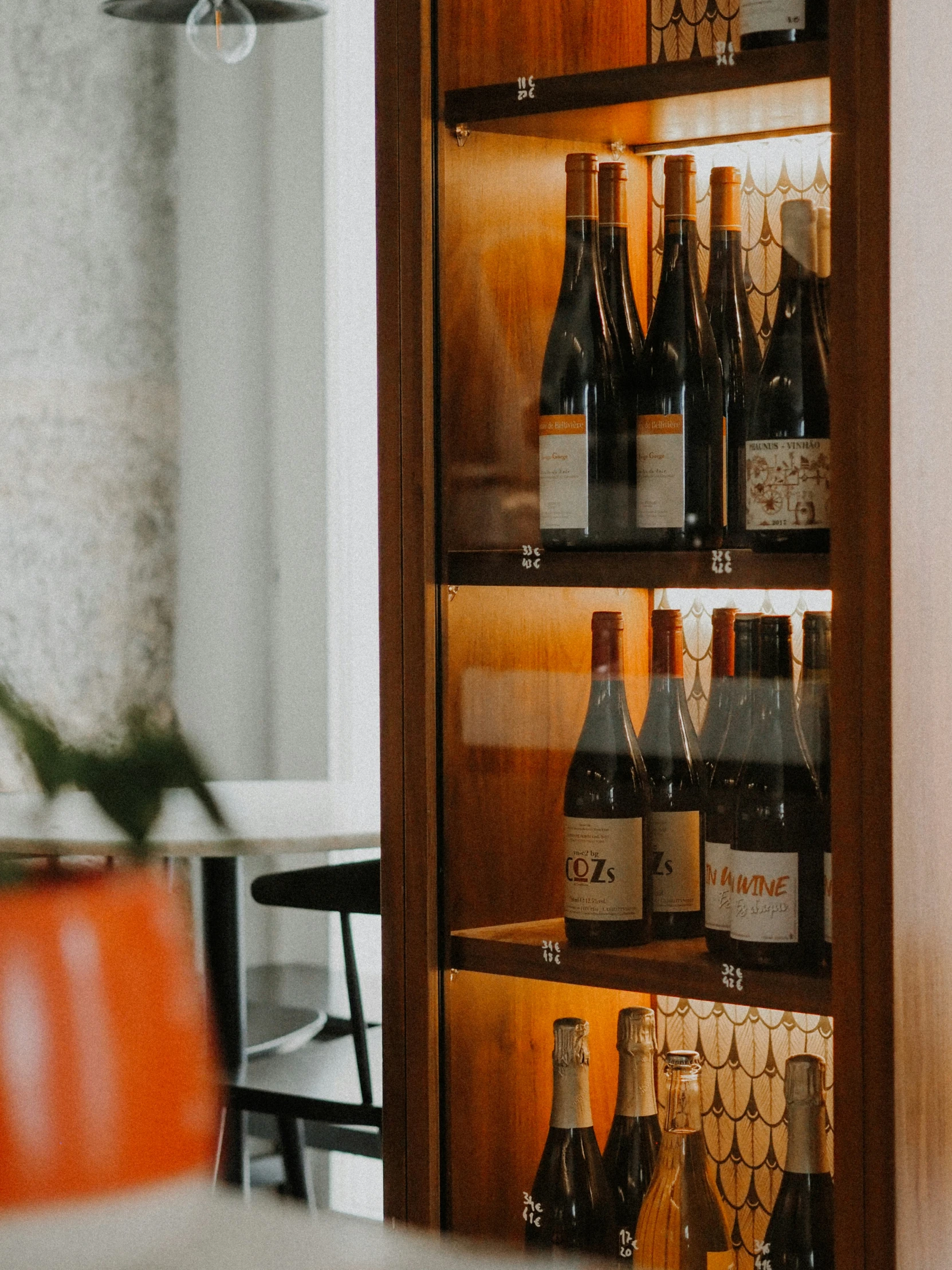 a wall filled with bottles of wine on display