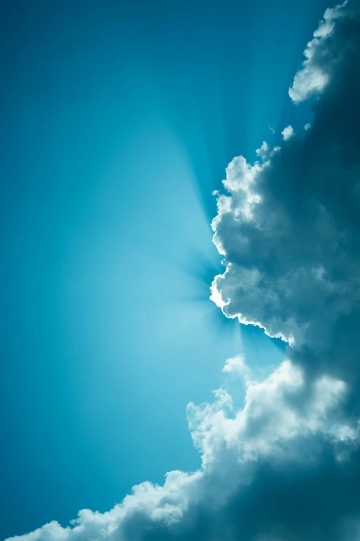 a very tall airplane in a blue cloudy sky