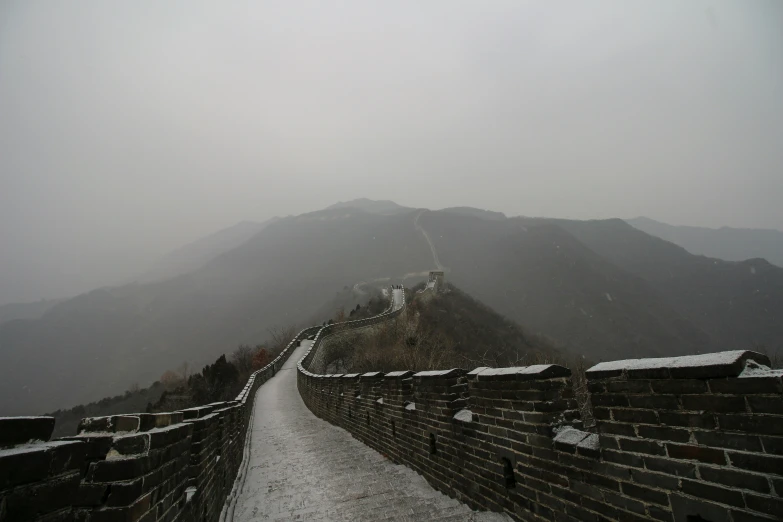 a snow covered mountain in the distance with many snow covering the ground