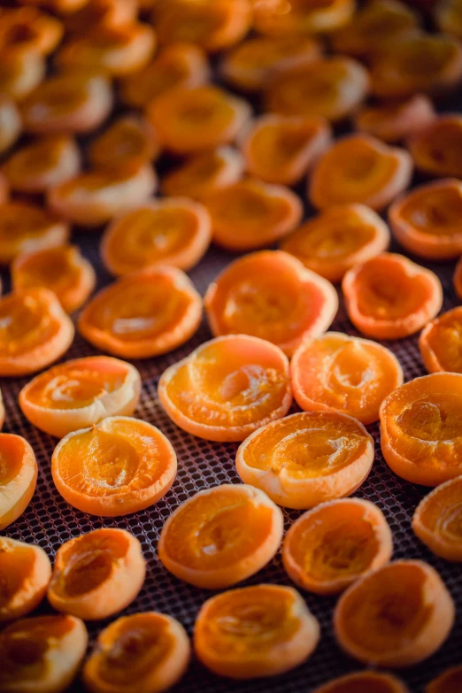 many peeled and cut oranges on a conveyor belt