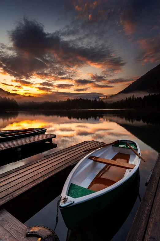 a boat sits on the dock at sunset