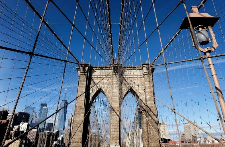 a traffic light is on the side of a tall bridge