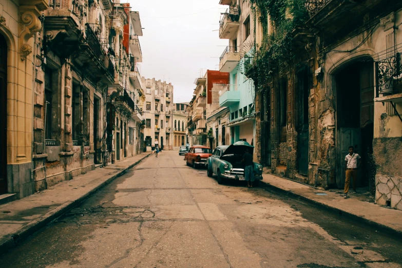 a dirty street has buildings in the back ground