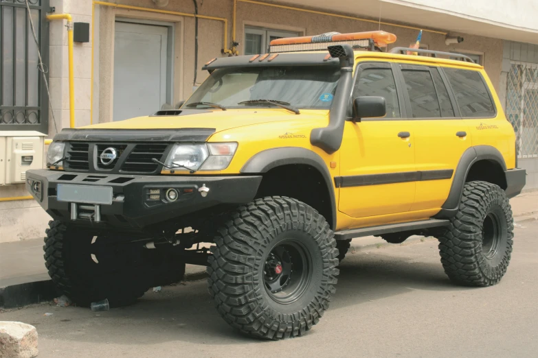 a yellow four wheel drive off road truck