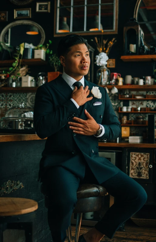 a man in a suit is sitting on a chair