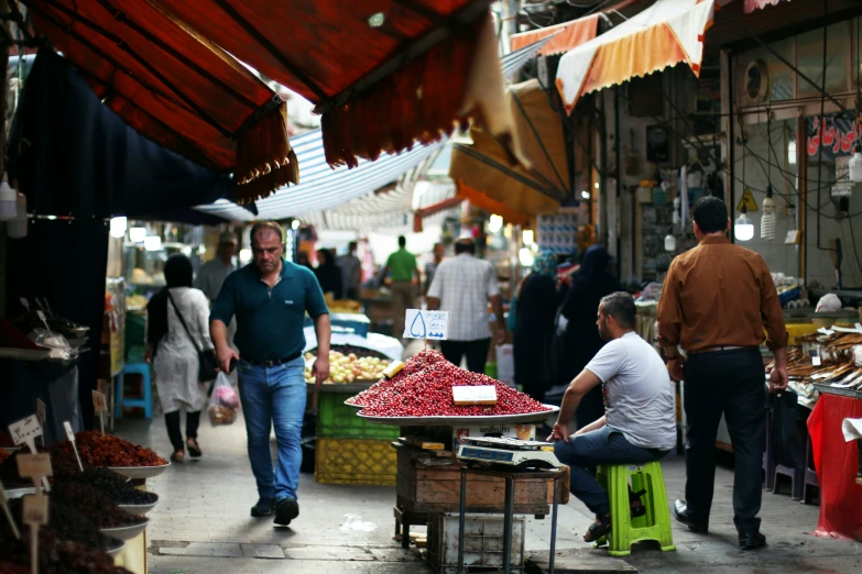 an image of a man looking at his belongings at a busy street market