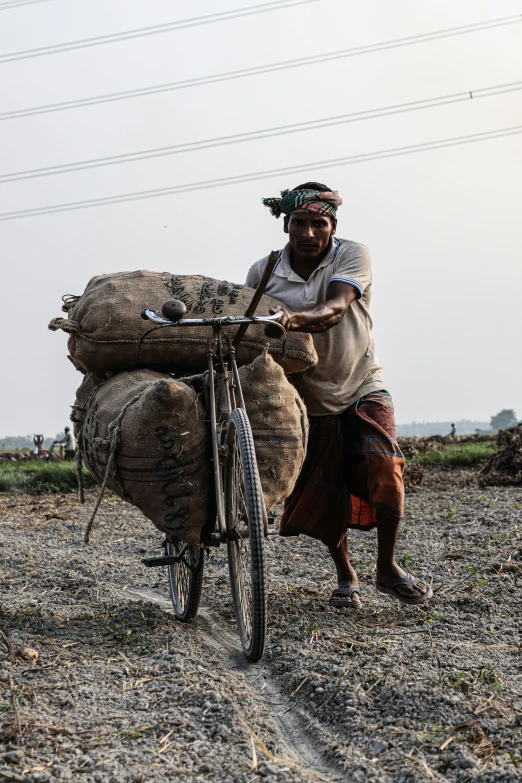 a man hing some logs on a bicycle