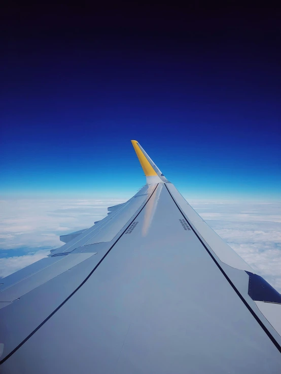 the wing and sky from a very high angle