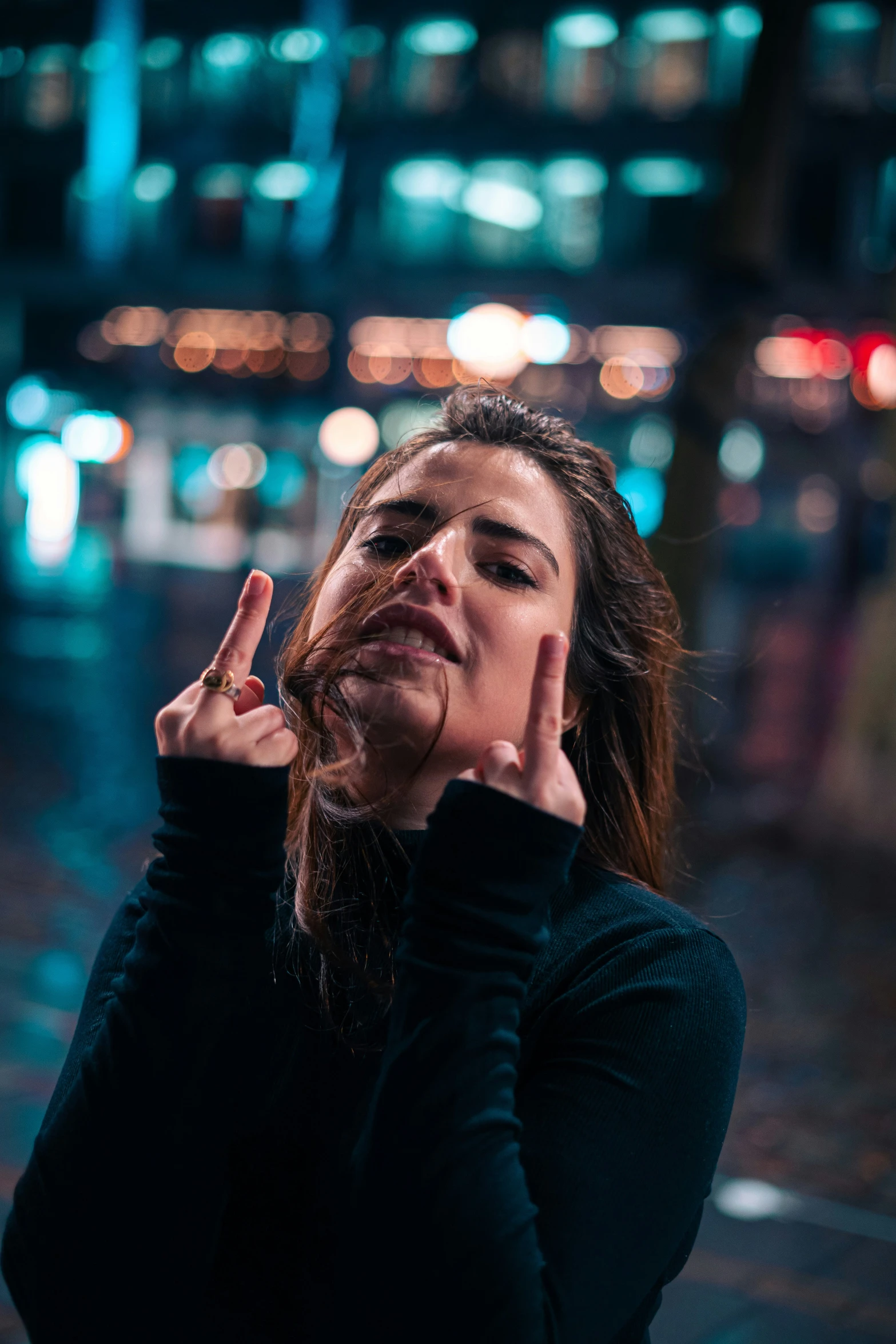 woman making stop gesture next to the street at night
