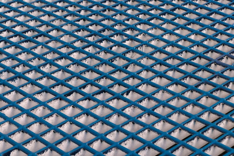 a textured metal surface with a blue pattern