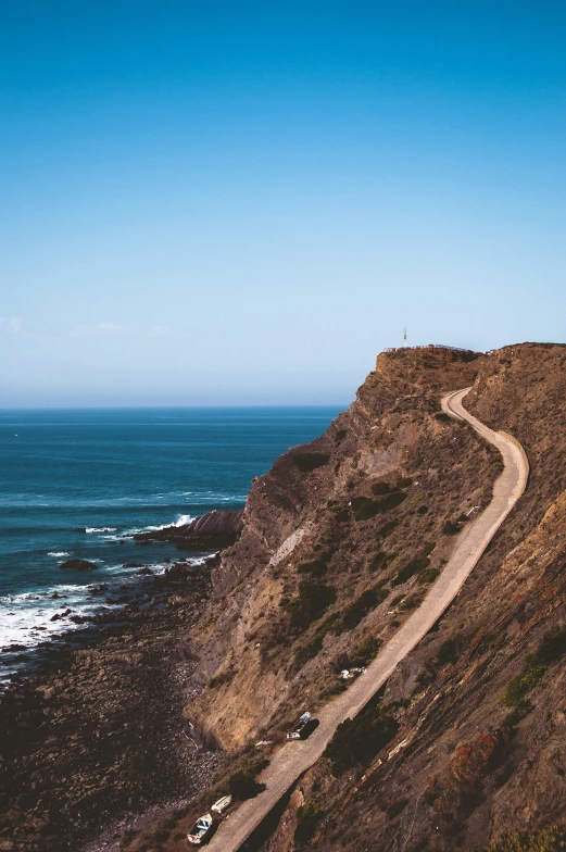 cars are driving down the mountain road