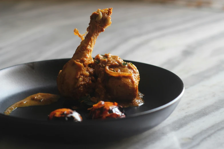 some fried food on a black bowl on a table