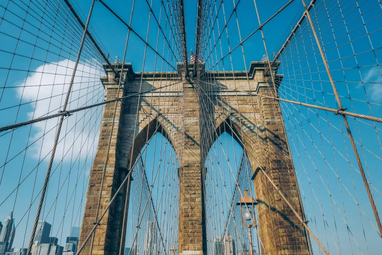 a large chain link bridge on the top of a hill