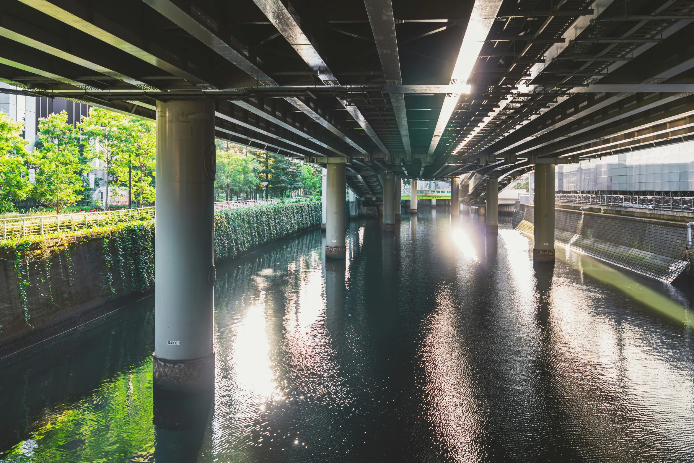 a view of the inside of an overpass with water under it