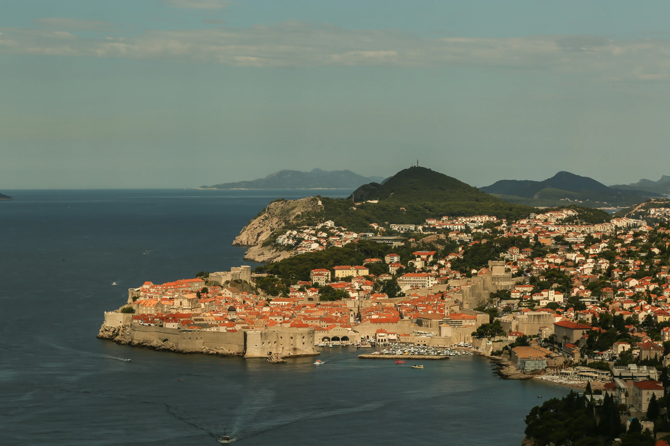 a small village sits between two mountains on a small island