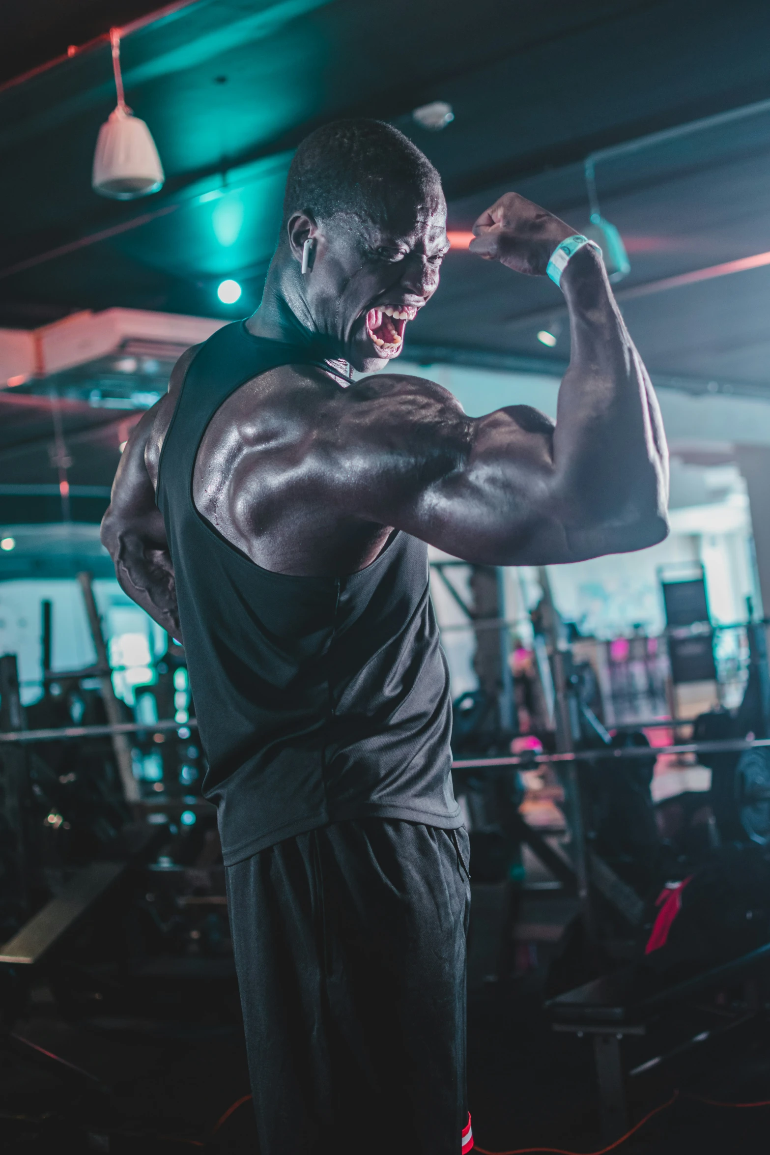 a man flexing his muscles in the gym