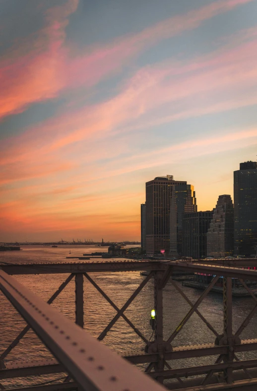 a view of cityscape from a bridge, looking east