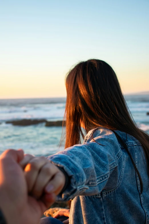 two people holding hands while standing next to each other