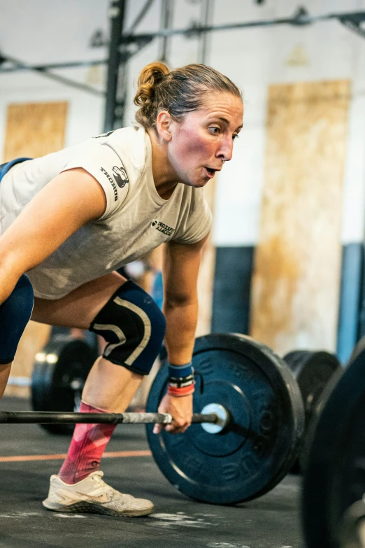 a woman doing a bench press on an incline bar