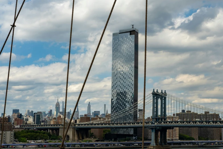 a view of a large bridge, tall buildings and a city