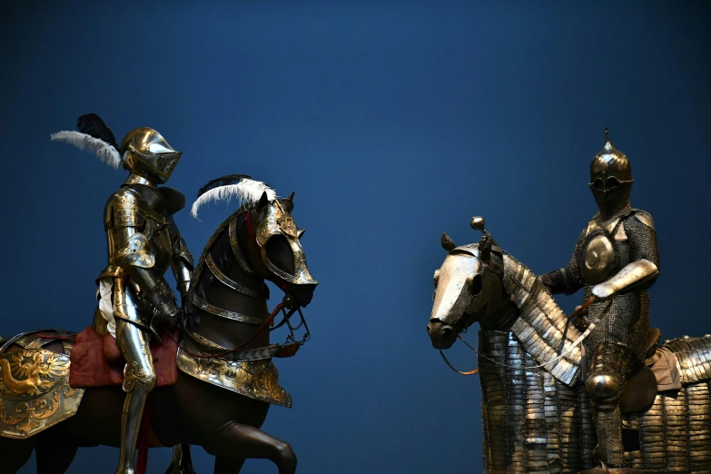 two knight statues sitting side by side on their horses