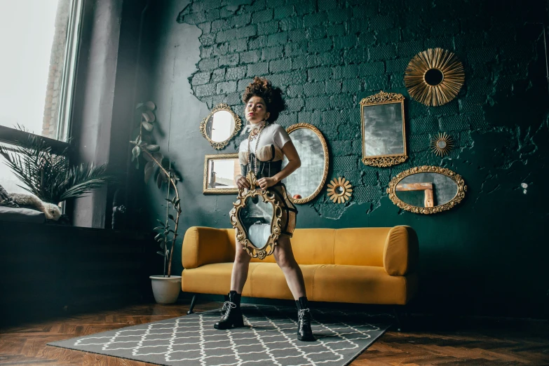 a woman poses in a room with her guitar in hand