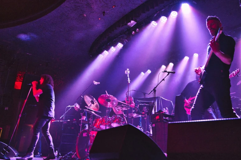 two band members on stage performing with their instruments