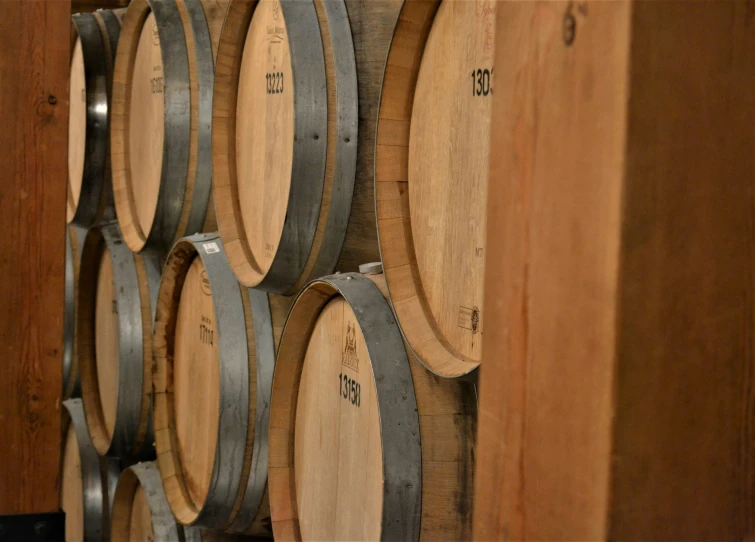 a number of wine barrels stacked on top of each other