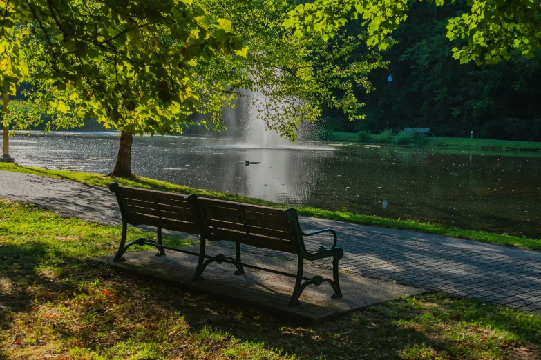 a wooden bench sitting next to the side of a road