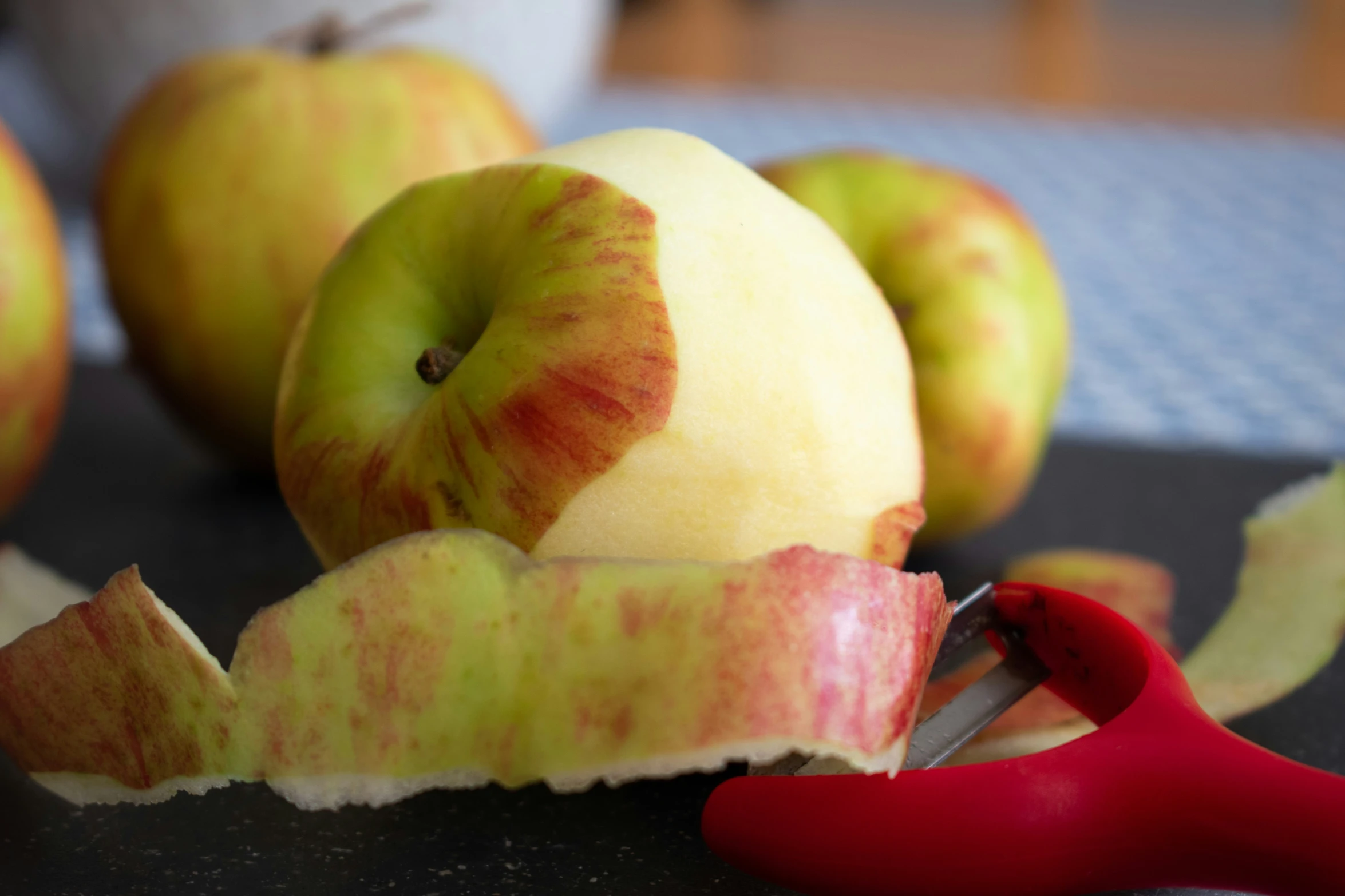 there is a knife in the apple being cut