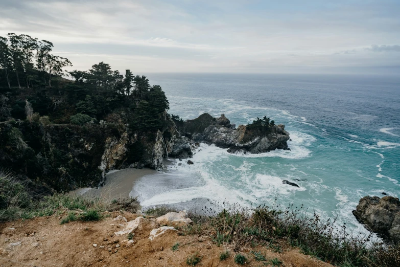 an ocean with a cliff and body of water