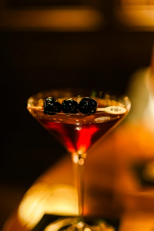 the martini is filled with black olives in it