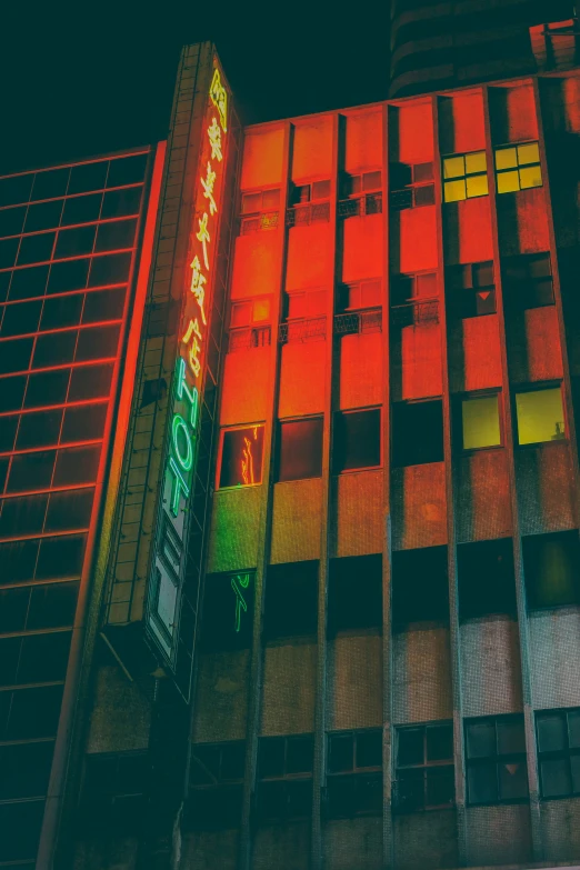 a bright neon sign is lit up near buildings