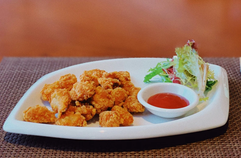 the plate of fried shrimp with a side of sauce