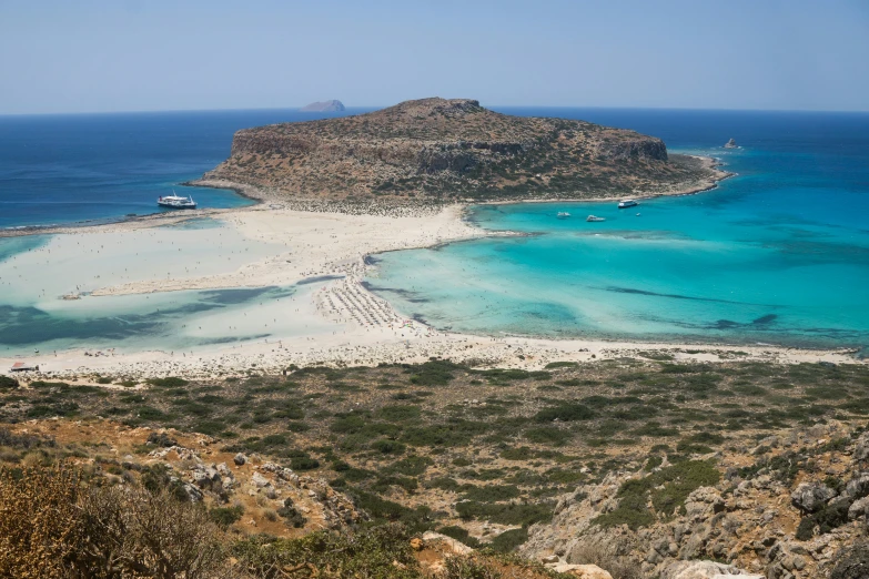 a large body of water with an island in the background