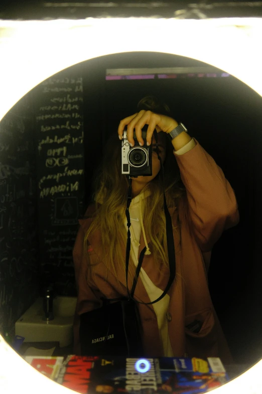 a person is holding a camera up in a circular frame
