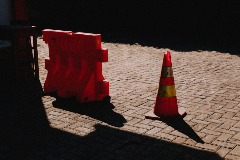 traffic cones on the ground behind orange traffic cones